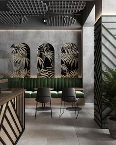 the interior of a modern restaurant with green and black chairs, palm leaves on the wall