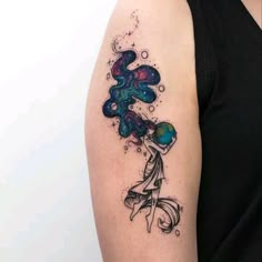 a woman's arm with a tattoo on it and an image of a flower