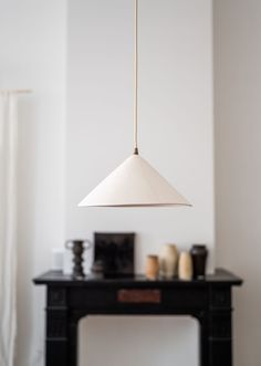 a white light hanging over a black table