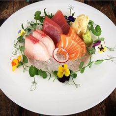 a white plate topped with different types of sushi