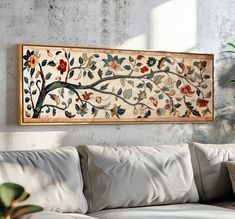 a painting hanging on the wall above a couch