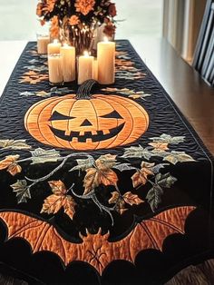 a decorated table with candles and pumpkins on it