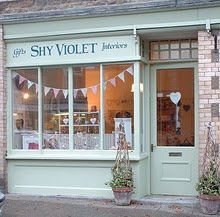 a store front with many windows and buntings on the side of the building