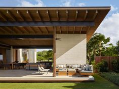 an outdoor living area with patio furniture and large open space on the side of the house