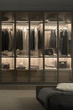 a walk in closet filled with lots of clothes