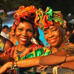 two women in colorful clothing standing next to each other