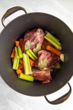 meat and vegetables cooking in a pan on the stove