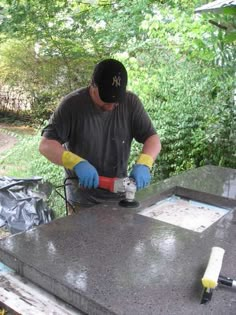 a man is sanding the top of a table