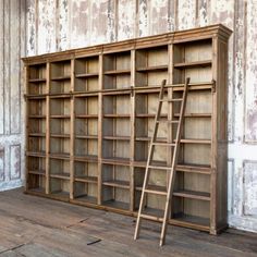 an old wooden bookcase with ladders in front of it and the words play written on