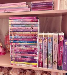 there are many princess dvds on the shelves in this room, all stacked up and ready to be filled with them