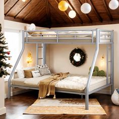 a metal bunk bed sitting on top of a hard wood floor next to a christmas tree