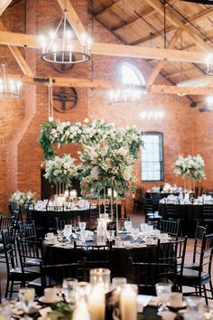 the tables are set up with candles and centerpieces