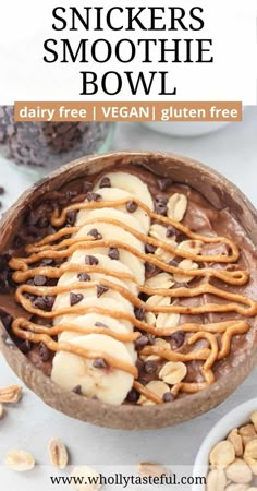 a bowl filled with peanut butter and chocolate snickkers smoothie bowl next to nuts