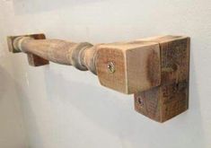 a wooden pipe is mounted to the wall