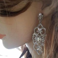 a close up of a person wearing some kind of earrings