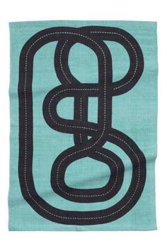 a blue and black towel with the letter b in it's center, on a white background