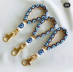 two blue and white beaded lanyards with gold clasps on each side