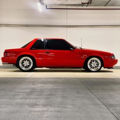 a red sports car parked in a garage