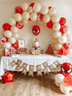 a spiderman themed birthday party with balloons and decorations