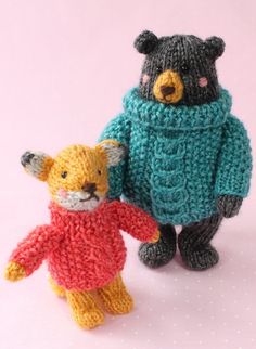 two knitted teddy bears standing next to each other