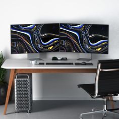 two computer monitors sitting on top of a desk