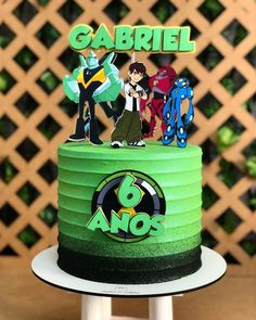 a green cake with cartoon characters on top and the words gabril above it