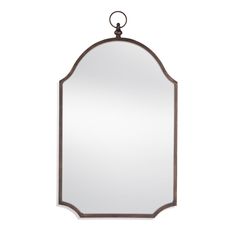 a mirror hanging on the wall with a metal frame and an oval shaped mirror above it