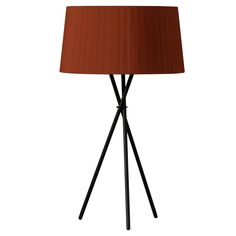 a lamp that is on top of a stand with a brown lampshade next to it