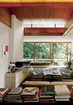 a living room filled with lots of furniture and books on top of a coffee table