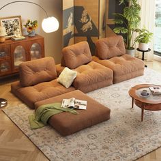 a living room filled with furniture and a large painting hanging on the wall above it