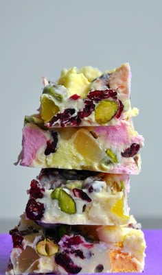 a stack of fruit and nut bars sitting on top of a purple surface