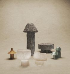 an assortment of different shapes and sizes of stools, tables and lamps on a concrete surface