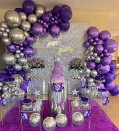 a purple and silver birthday party with balloons