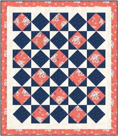 an orange and blue quilt with white flowers on the border, in front of a red background