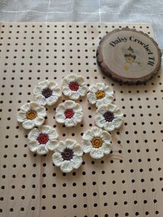 crocheted flowers and a wooden slice on a table