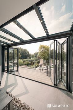 an open patio with sliding glass doors leading to a deck