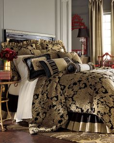 a bed with gold and black comforters in a room