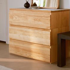 a wooden dresser with a mirror on top of it