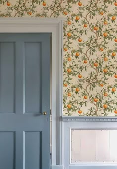 an orange wallpapered room with blue doors