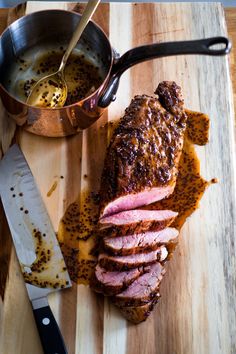 the meat is sliced up and ready to be served on the cutting board with a knife