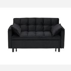 a black couch sitting on top of a white floor