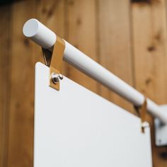 a white board mounted to the side of a wooden wall