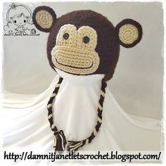 a crocheted monkey hat with braids on it