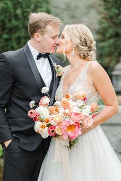 the bride and groom are kissing each other