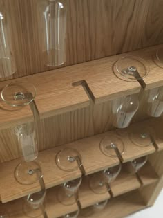 several wine glasses are lined up on a shelf