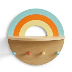 a wall mounted wooden toy with an orange, blue and yellow circle