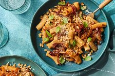 two plates with pasta and vegetables on them