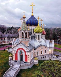 an aerial view of a church with colorful domes