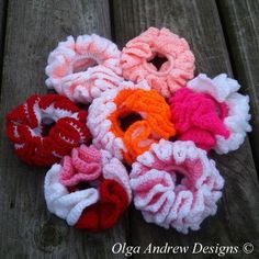 several crocheted scrunffles laying on a wooden surface