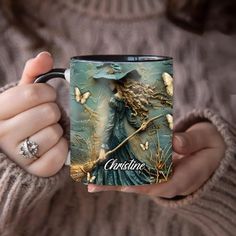 a woman holding a coffee mug with an image on it